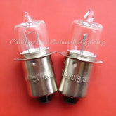 Close-up of two 7.2V 0.85A P13.5S base halogen bulb lights on red background
